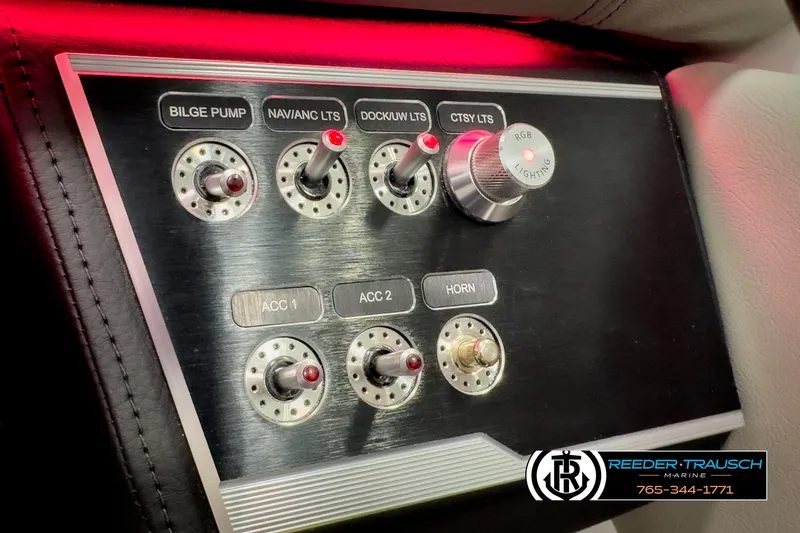 Slide: The Image of Control panel of 2025 Four Winns HD3 boat with switches and RGB lighting knob. - 35
