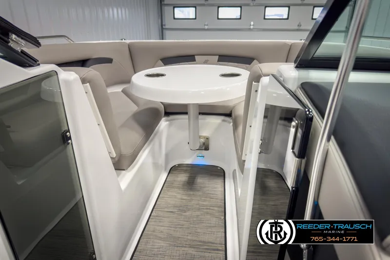 Slide: The Image of 2025 Four Winns HD3 boat interior with seating and table, showcased by Reeder-Trausch Marine. - 46