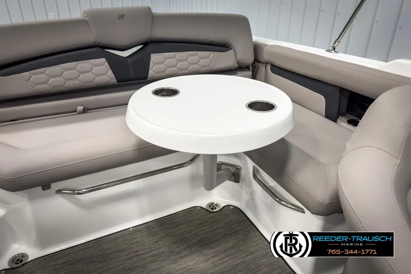 Slide: The Image of 2025 Four Winns HD3 boat interior with round table and cushioned seating. - 47