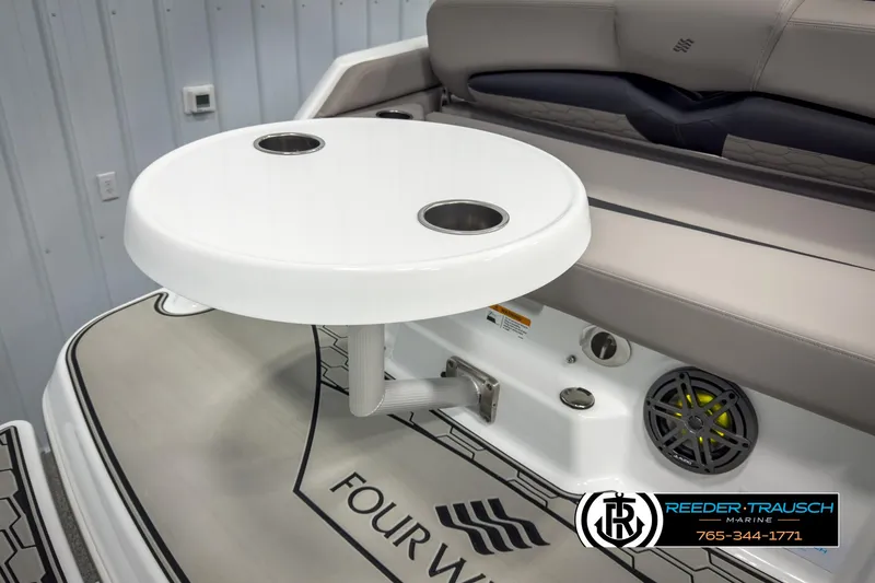 Slide: The Image of 2025 Four Winns HD3 boat interior with round table and seating area. - 48