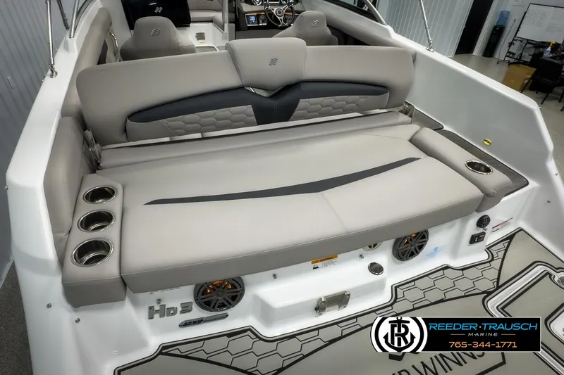 Slide: The Image of 2025 Four Winns HD3 boat interior with cushioned seating and cup holders. - 49