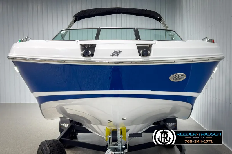 Slide: The Image of 2025 Four Winns HD3 boat in showroom, blue and white hull, front view. - 8