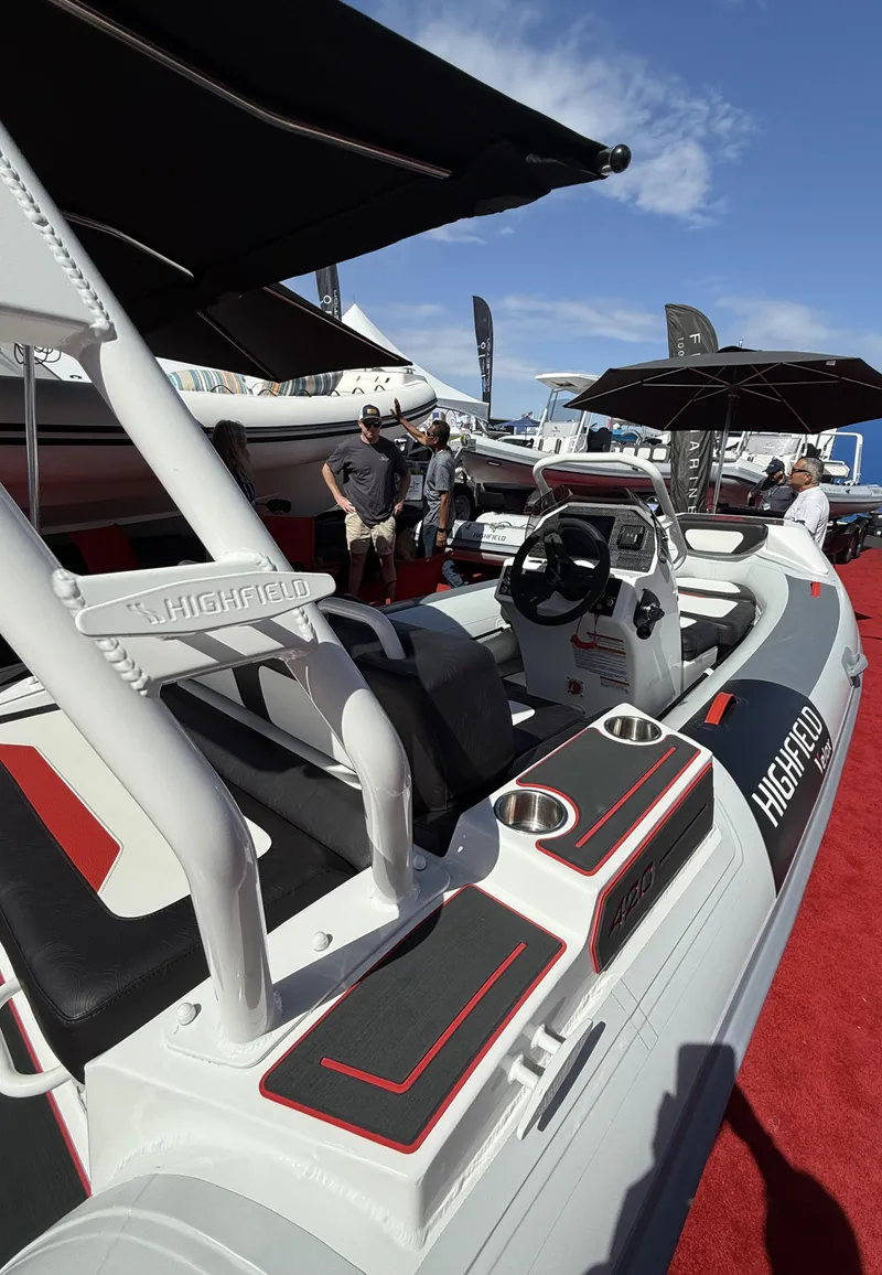 Slide: The Image of 2025 Highfield Velox 420 boat displayed at an outdoor event, featuring sleek design and modern features. - 3