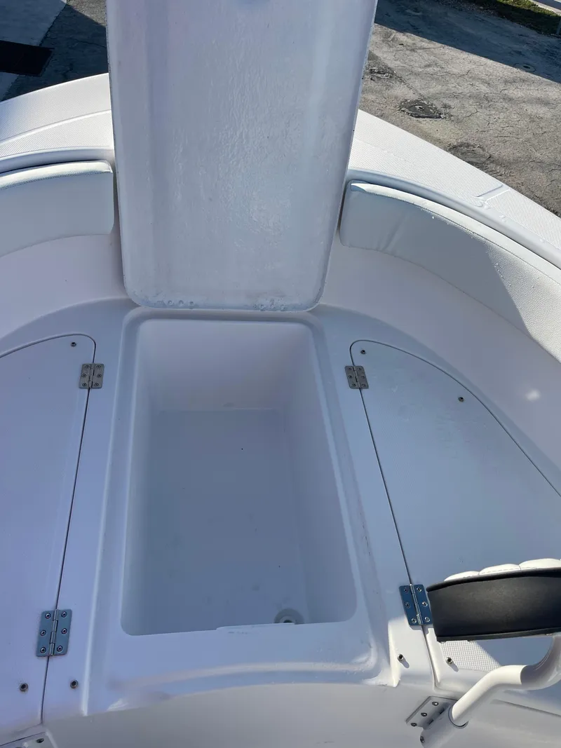 Slide: The Image of 2025 Clearwater 2200 WI Center Console boat storage compartment open. - 10