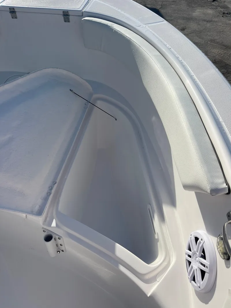 Slide: The Image of 2025 Clearwater 2200 WI Center Console boat interior with storage compartment and speaker. - 11