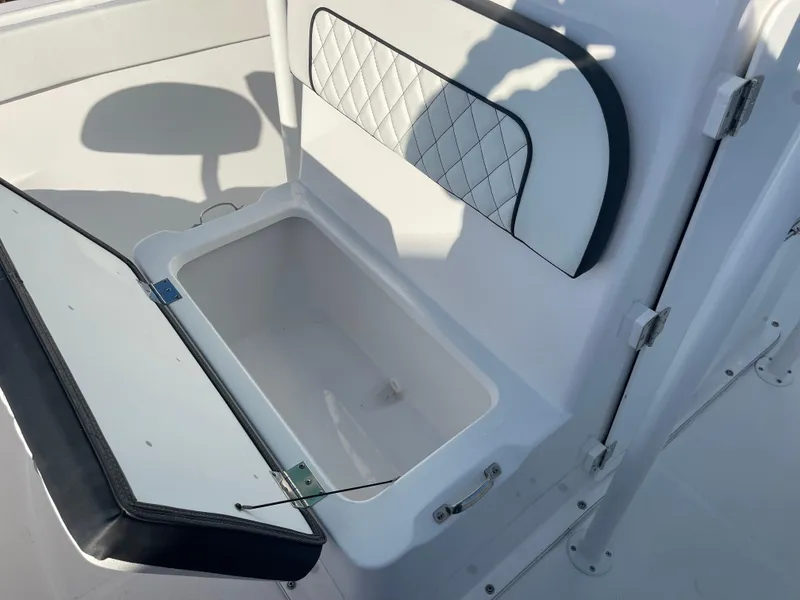 Slide: The Image of Open storage compartment on 2025 Clearwater 2200 WI Center Console boat. - 14