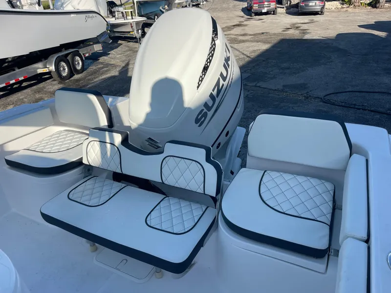 Slide: The Image of 2025 Clearwater 2200 WI Center Console boat with Suzuki engine and cushioned seating. - 18