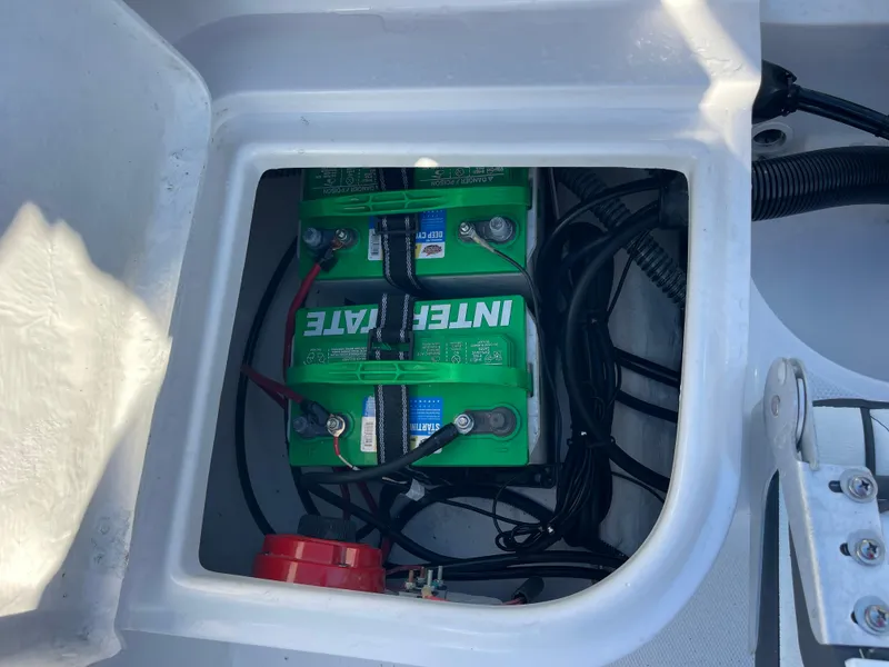 Slide: The Image of 2025 Clearwater 2200 WI Center Console battery compartment with wiring and Interstate batteries. - 20