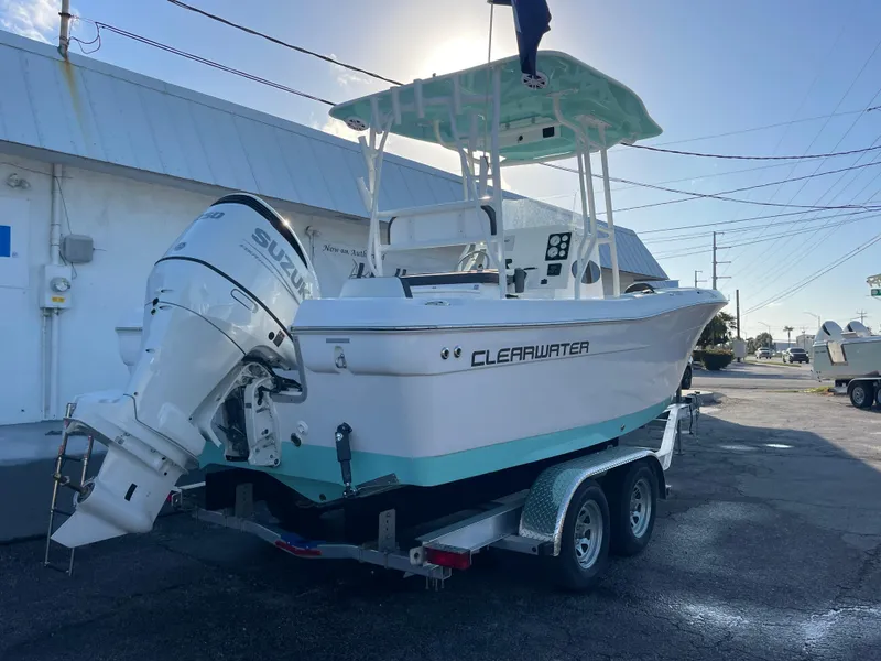 Slide: The Image of 2025 Clearwater 2200 WI Center Console boat on trailer, parked outdoors. - 3