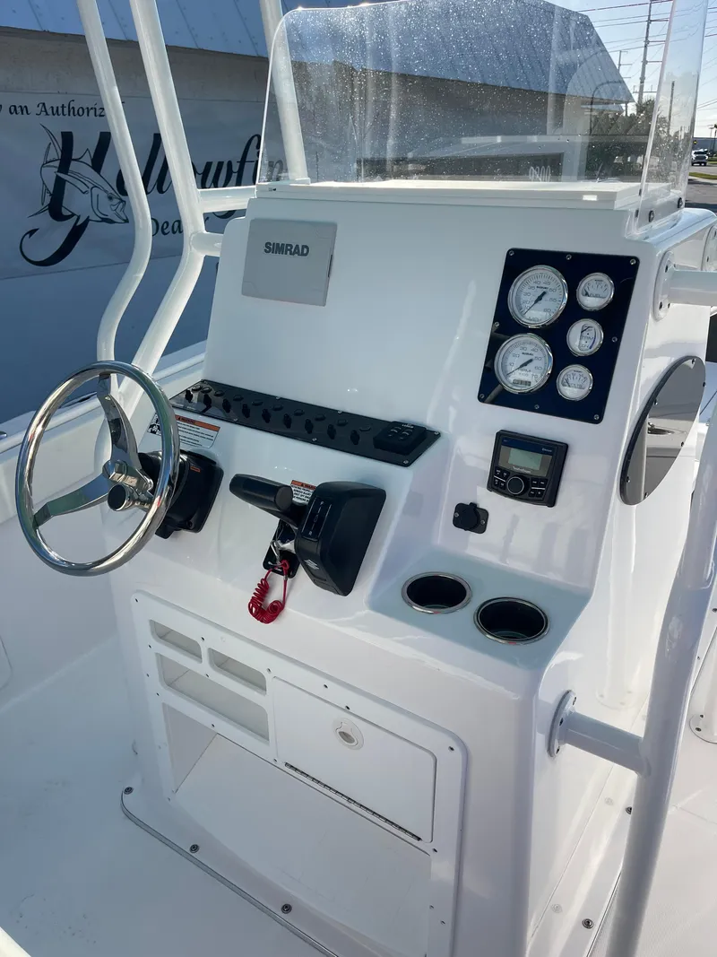Slide: The Image of 2025 Clearwater 2200 WI Center Console boat dashboard with steering wheel and gauges. - 6