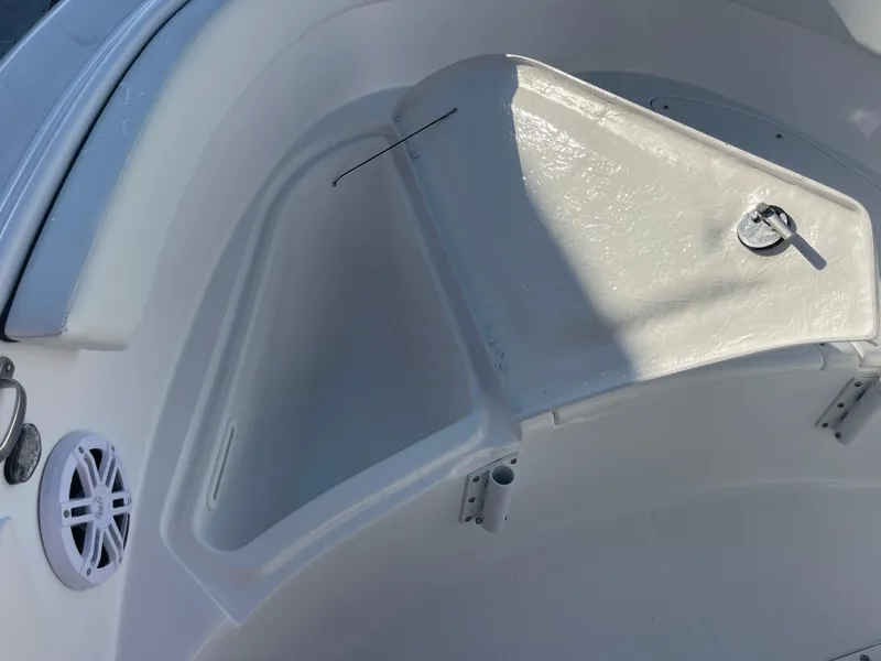 Slide: The Image of 2025 Clearwater 2200 WI Center Console boat interior with storage compartment and speaker. - 9