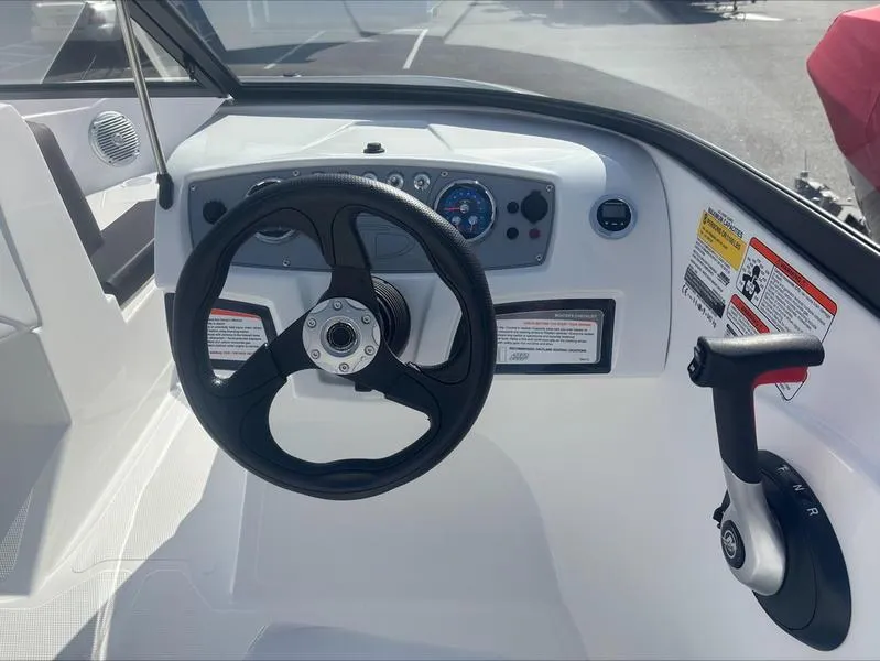 Slide: The Image of 2025 Tahoe 185 S boat dashboard with steering wheel and control panel. - 10