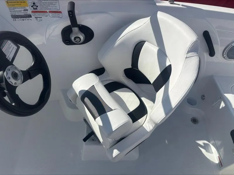 Slide: The Image of 2025 Tahoe 185 S boat interior with white and black captain's chair and steering wheel. - 11