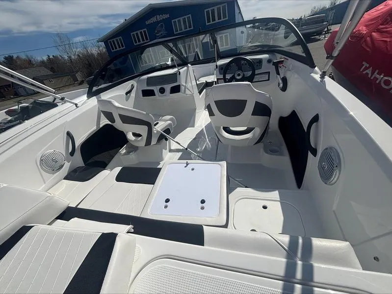 Slide: The Image of 2025 Tahoe 185 S boat interior with modern seating and steering console. - 2