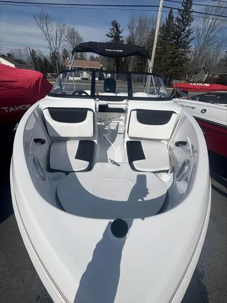Slide: The Image of 2025 Tahoe 185 S boat with sleek white interior and black accents, parked outdoors. - 5
