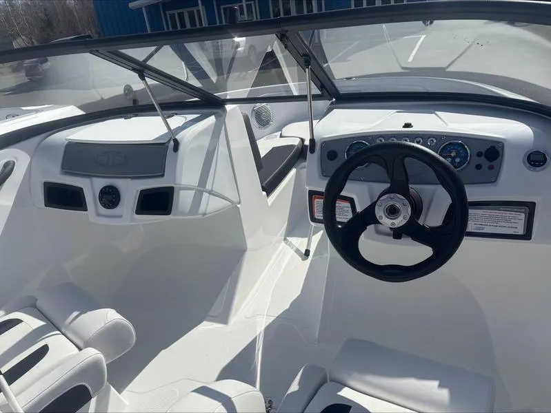 Slide: The Image of 2025 Tahoe 185 S boat interior with steering wheel and dashboard controls. - 9