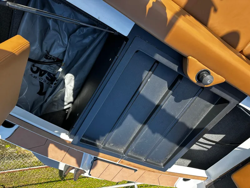 Slide: The Image of 2022 Axis A24 boat interior storage compartment with tan seating. - 10