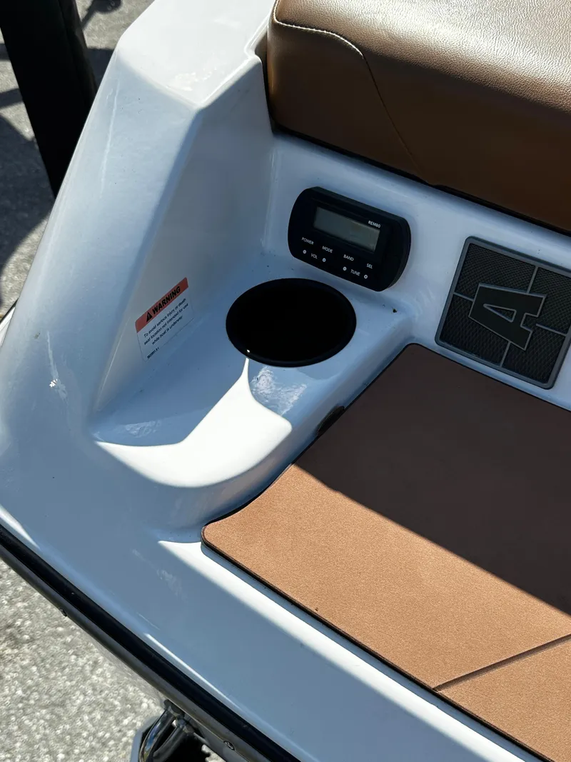 Slide: The Image of 2022 Axis A24 boat interior with cup holder and control panel. - 16