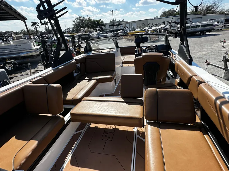 Slide: The Image of 2022 Axis A24 boat interior with tan seating and open deck layout. - 17