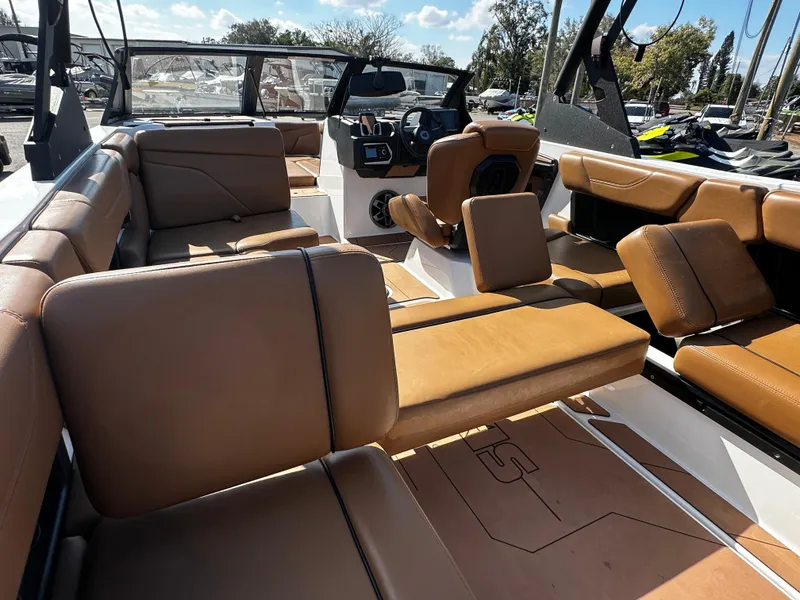 Slide: The Image of 2022 Axis A24 boat interior with tan leather seating and modern dashboard. - 18