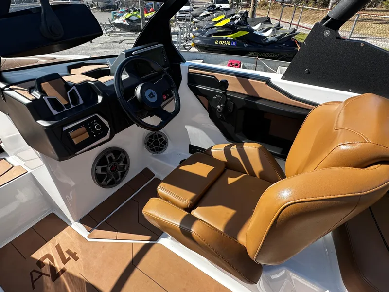 Slide: The Image of 2022 Axis A24 boat interior with tan leather seats and modern dashboard. - 19
