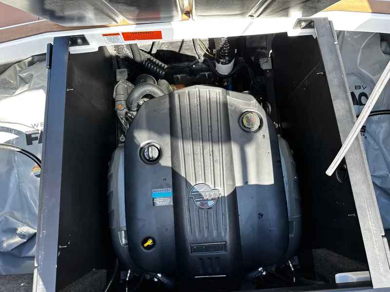 Slide: The Image of 2022 Axis A24 boat engine compartment with visible components and branding. - 23
