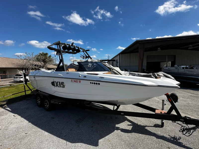 Slide: The Image of 2022 Axis A24 boat on trailer under clear blue sky. - 3