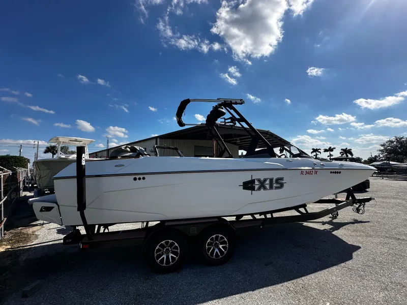 Slide: The Image of 2022 Axis A24 boat on trailer under clear blue sky. - 4