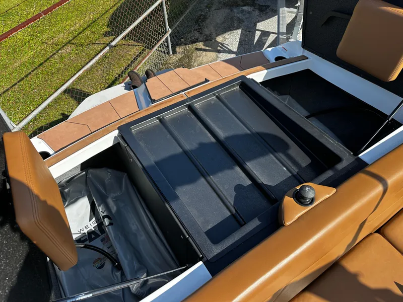 Slide: The Image of 2022 Axis A24 boat interior with tan seats and storage compartments. - 9
