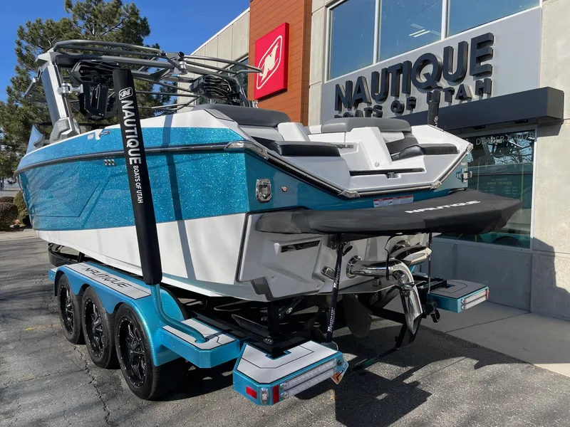 Slide: The Image of 2022 Nautique Super Air Nautique G25 boat on trailer outside dealership. - 3