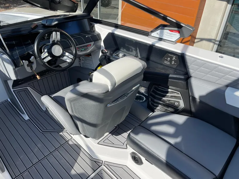 Slide: The Image of 2022 Nautique Super Air Nautique G25 interior with modern helm and seating. - 6