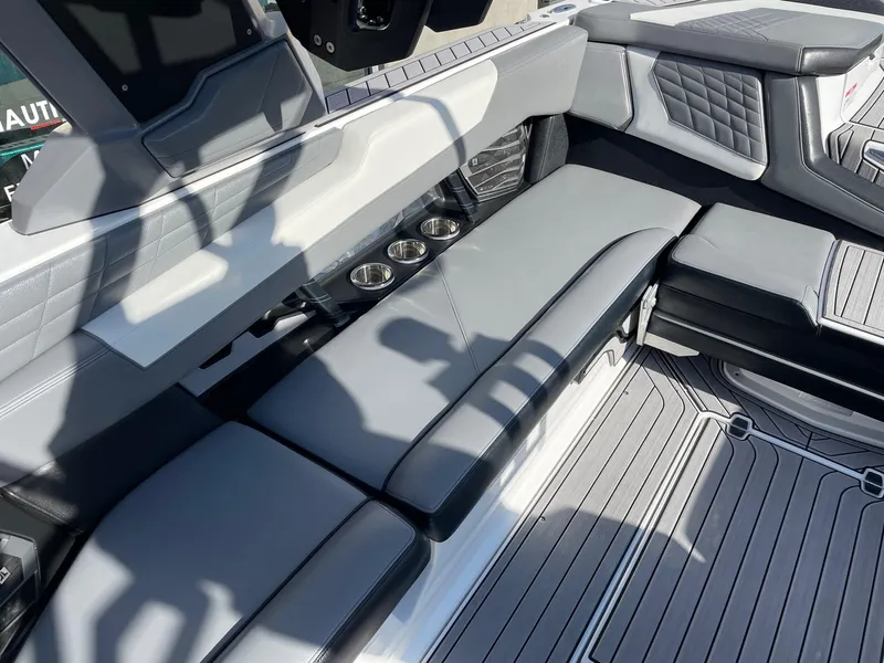 Slide: The Image of 2022 Nautique Super Air Nautique G25 interior with gray seating and cup holders. - 7
