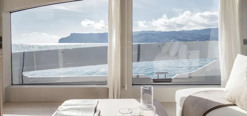 Slide: The Image of Luxurious interior view from 2025 Azimut Seadeck 6 yacht, overlooking ocean and coastline. - 10