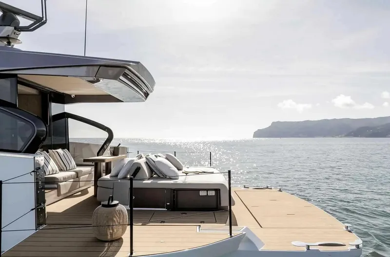 Slide: The Image of Luxurious Azimut Seadeck 6 yacht deck, 2025 model, overlooking serene ocean and distant coastline. - 5