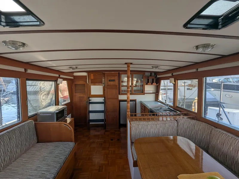 Slide: The Image of Interior of 1985 Roughwater 41 Pilothouse with wood finishes and large windows. - 10