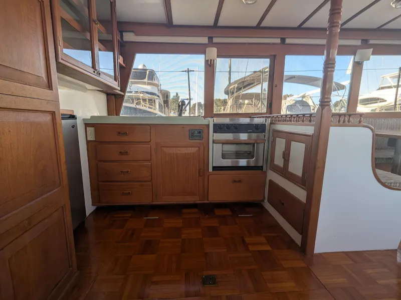 Slide: The Image of 1985 Roughwater 41 Pilothouse interior with wood cabinetry and parquet flooring. - 12