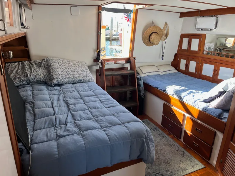 Slide: The Image of Interior of 1985 Roughwater 41 Pilothouse with twin beds and nautical decor. - 14