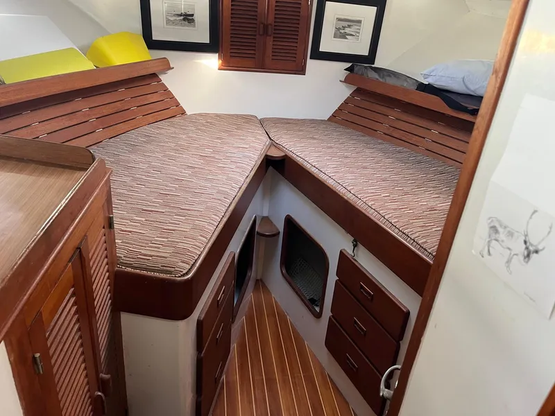 Slide: The Image of 1985 Roughwater 41 Pilothouse interior with twin beds and wooden cabinetry. - 15