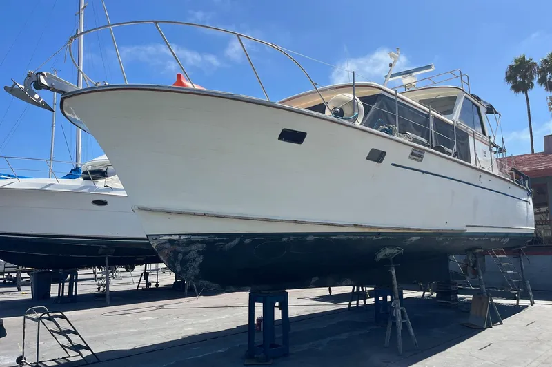 Slide: The Image of 1985 Roughwater 41 Pilothouse boat on dry dock under clear blue sky. - 16