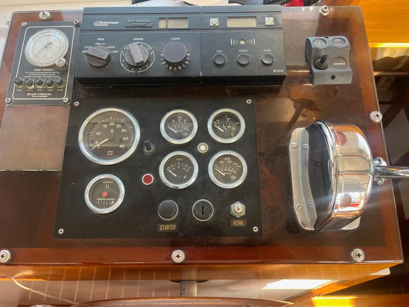 Slide: The Image of Control panel of a 1985 Roughwater 41 Pilothouse boat with gauges and switches. - 3