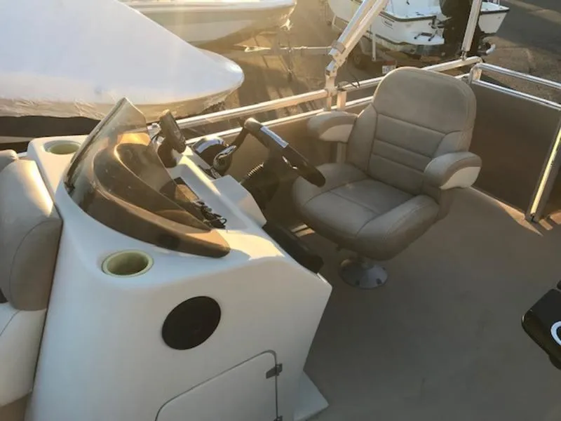 Slide: The Image of 2013 Cypress Cay Seabreeze 180 boat interior with captain's chair and steering console. - 11