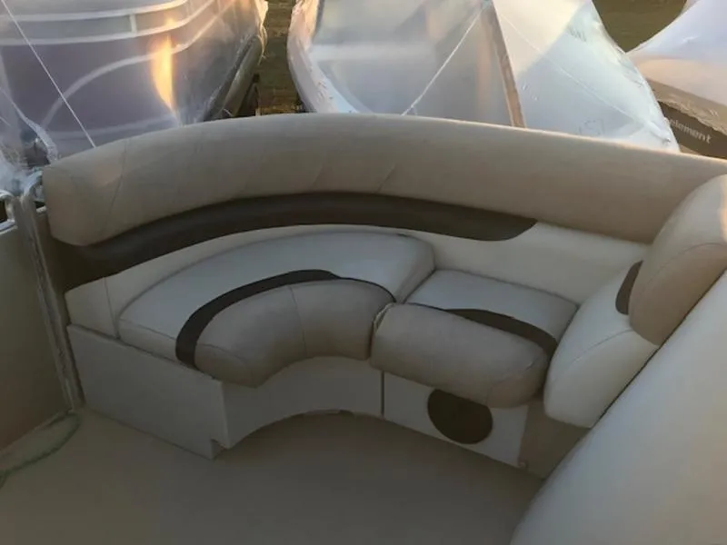 Slide: The Image of 2013 Cypress Cay Seabreeze 180 boat interior with beige and black seating. - 14