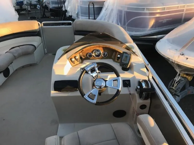 Slide: The Image of 2013 Cypress Cay Seabreeze 180 boat interior with steering wheel and dashboard controls. - 8