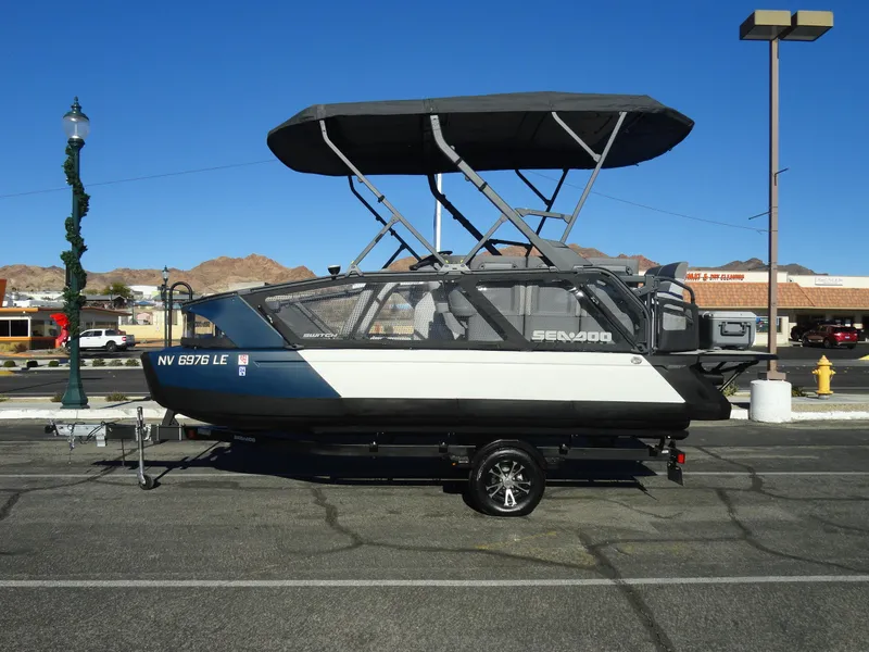 Slide: The Image of 2024 Sea-Doo Switch Sport 18 - 230 HP boat with canopy on trailer. - 1