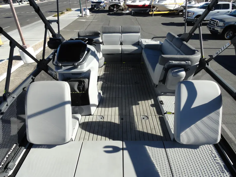 Slide: The Image of 2024 Sea-Doo Switch Sport 18 interior with seating and controls, parked outdoors. - 19