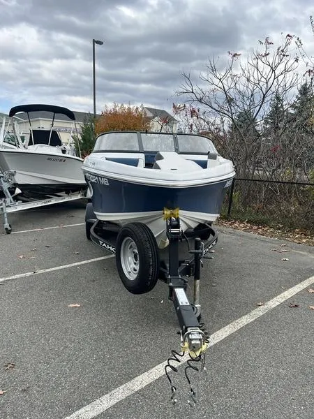 Slide: The Image of 2021 Tahoe 450 TS boat on trailer in parking lot, overcast sky. - 3