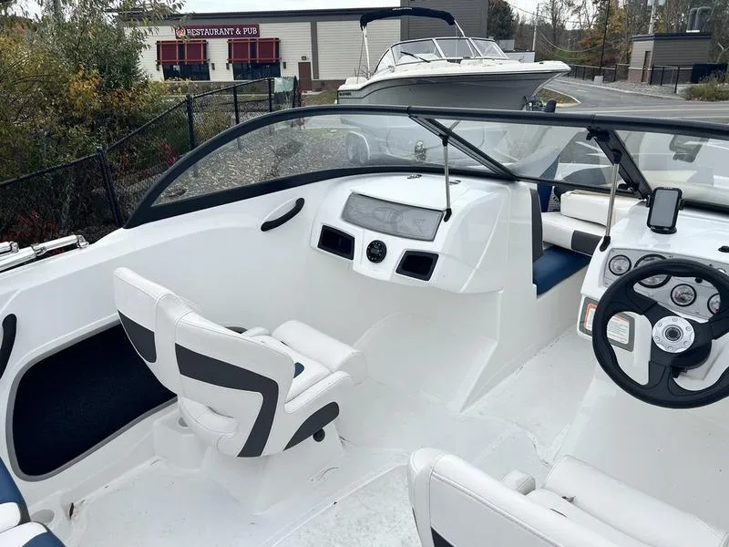 Slide: The Image of 2021 Tahoe 450 TS boat interior with steering wheel and seating. - 7