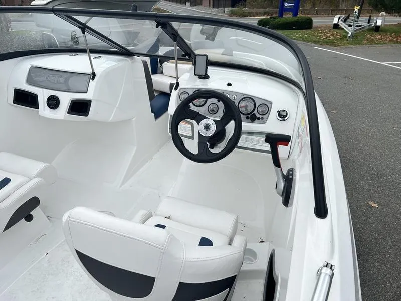Slide: The Image of 2021 Tahoe 450 TS boat interior with steering wheel and dashboard controls. - 8