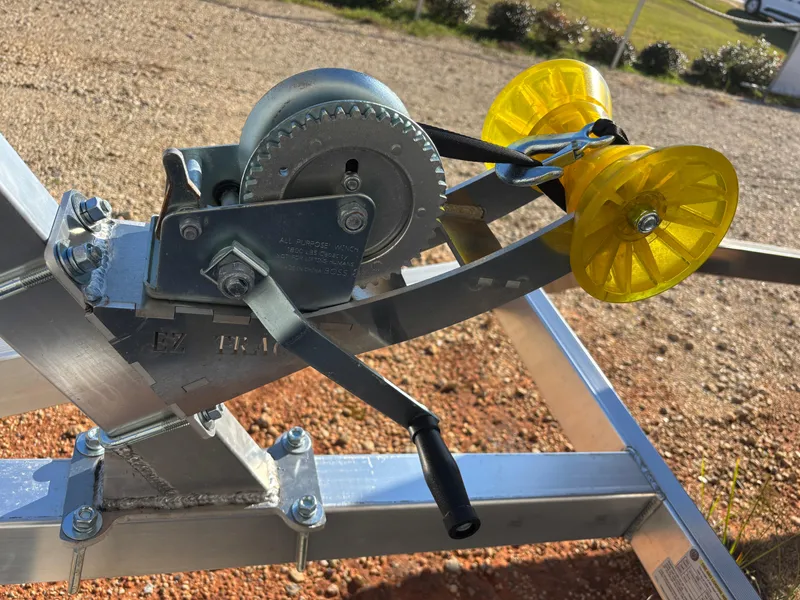 Slide: The Image of Close-up of a 2025 Edge Duck Boats 756DB trailer winch and yellow rollers. - 35