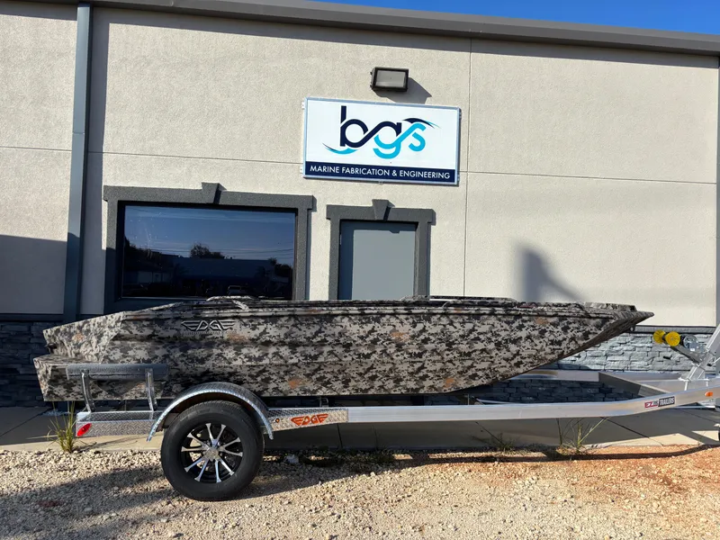 The Image of 2025 Edge Duck Boats 756DB on trailer outside marine fabrication building. - 1